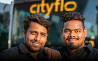 Our two professional bus drivers standing in front of a Cityflo bus for rentals from Maharashtra to Lonavala.